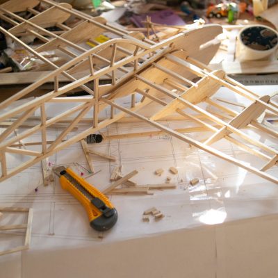 Making,Model,Airplane,From,Balsa,Wood.,Handcrafted,On,Work,Table